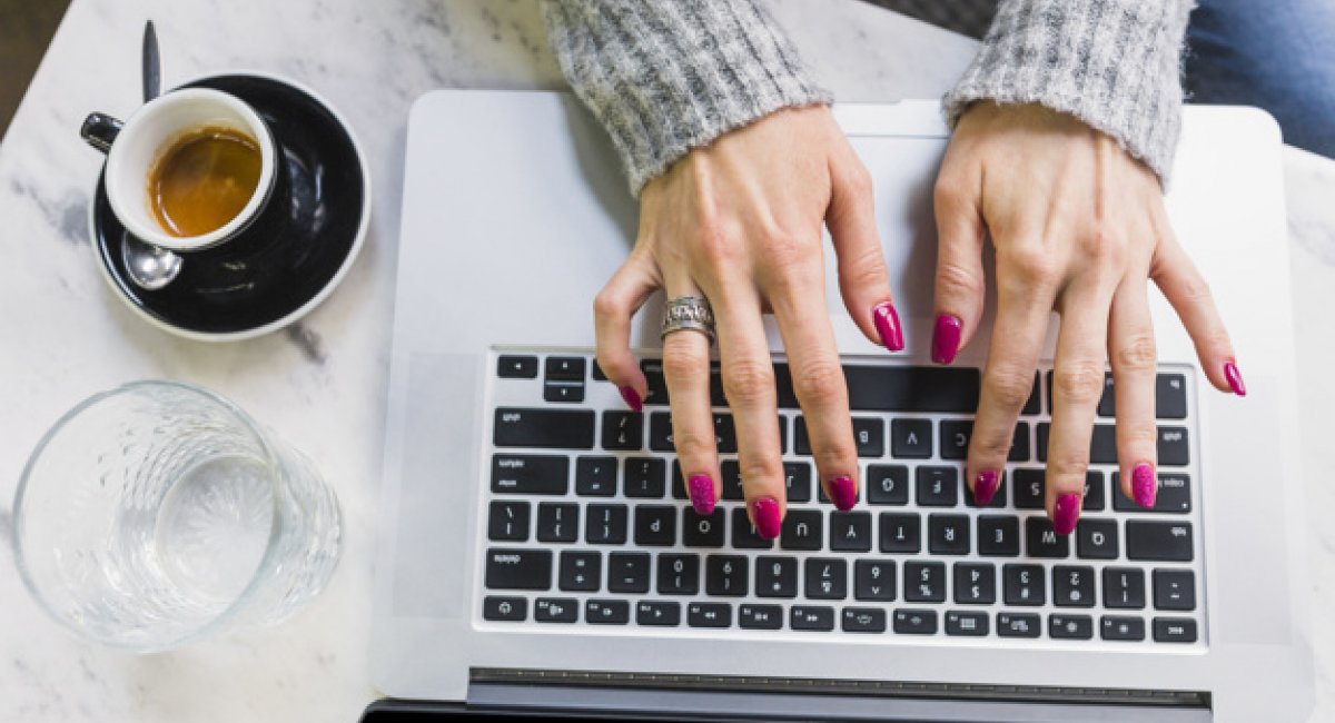 female hands typing on laptop