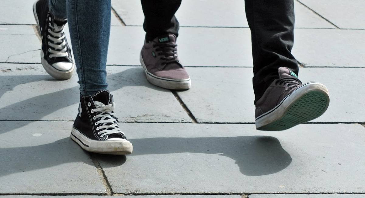 Shadow your teacher Feet of two people walking together with sneakers on