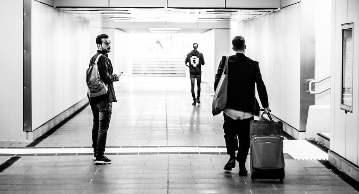 Review! Man looking back in a hallway