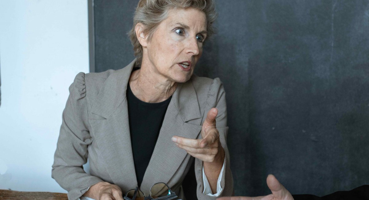 Stop talking—I have another question. Older businesswoman with a harsh look on her face
