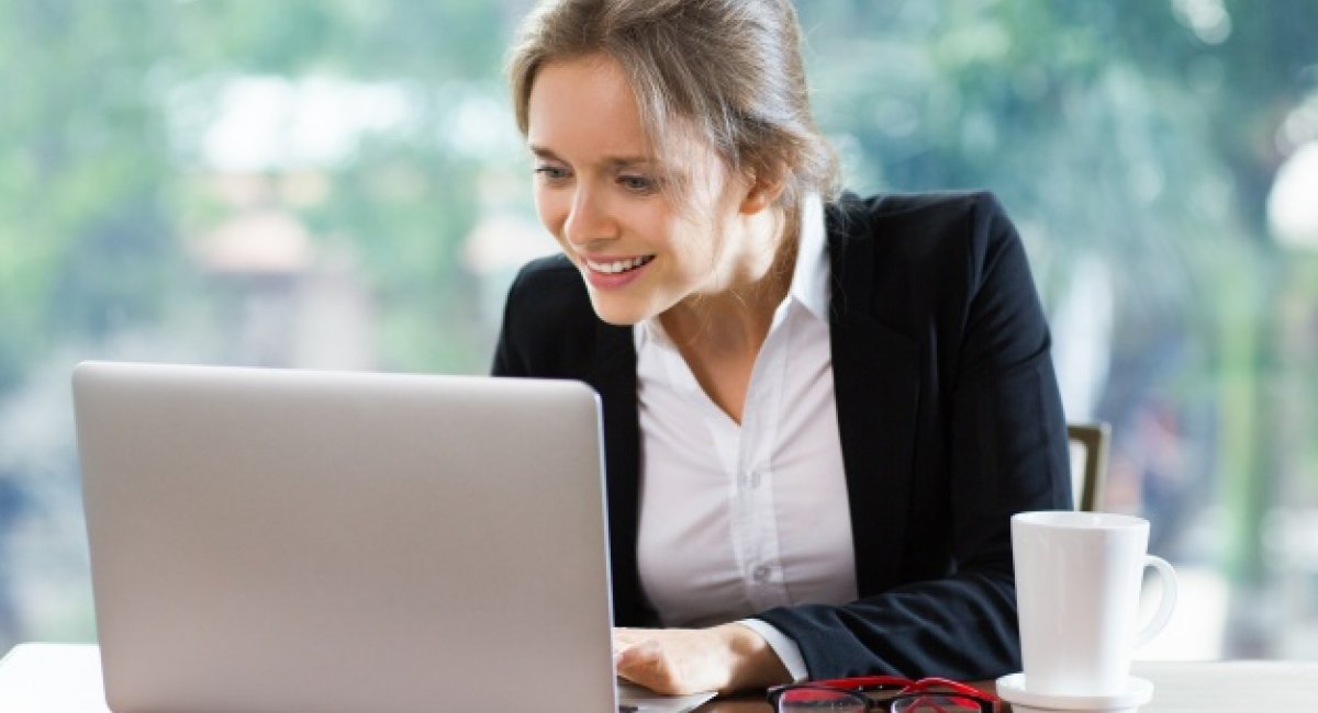 Thank you so much for your time. Smiling businesswoman sitting in front of a laptop