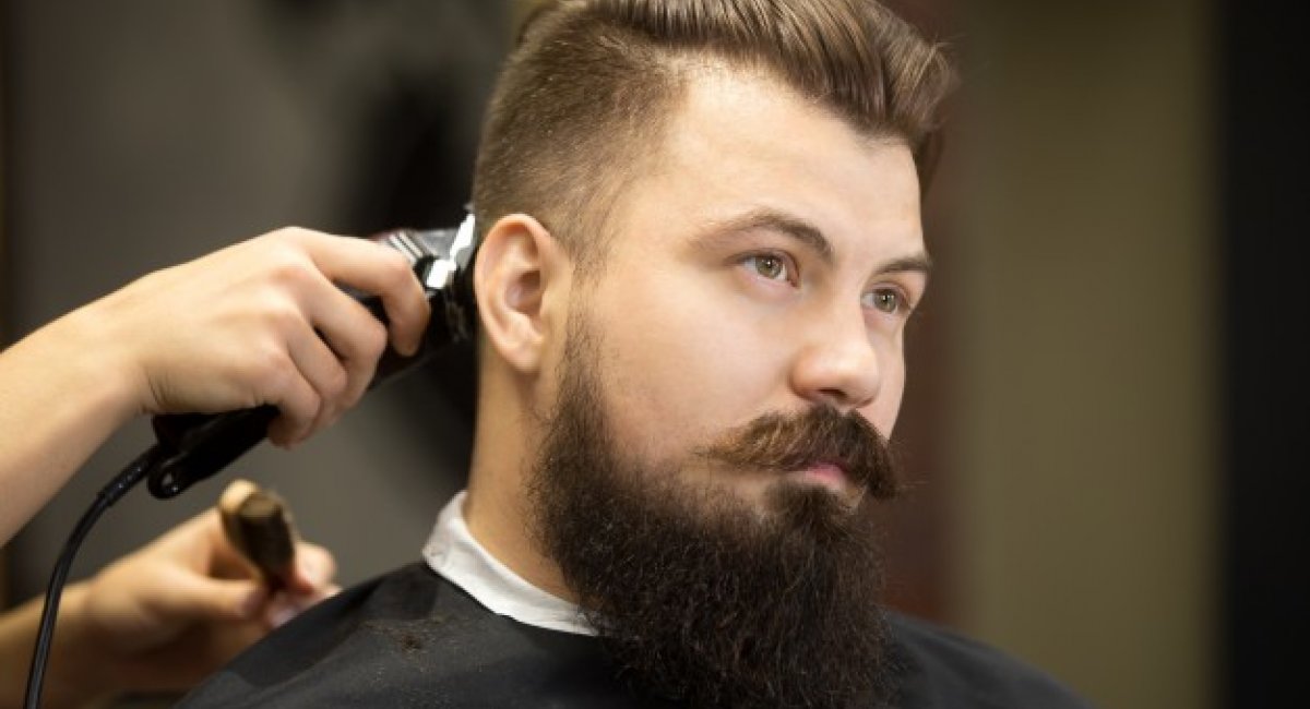 young bearded man in hairdresser salon