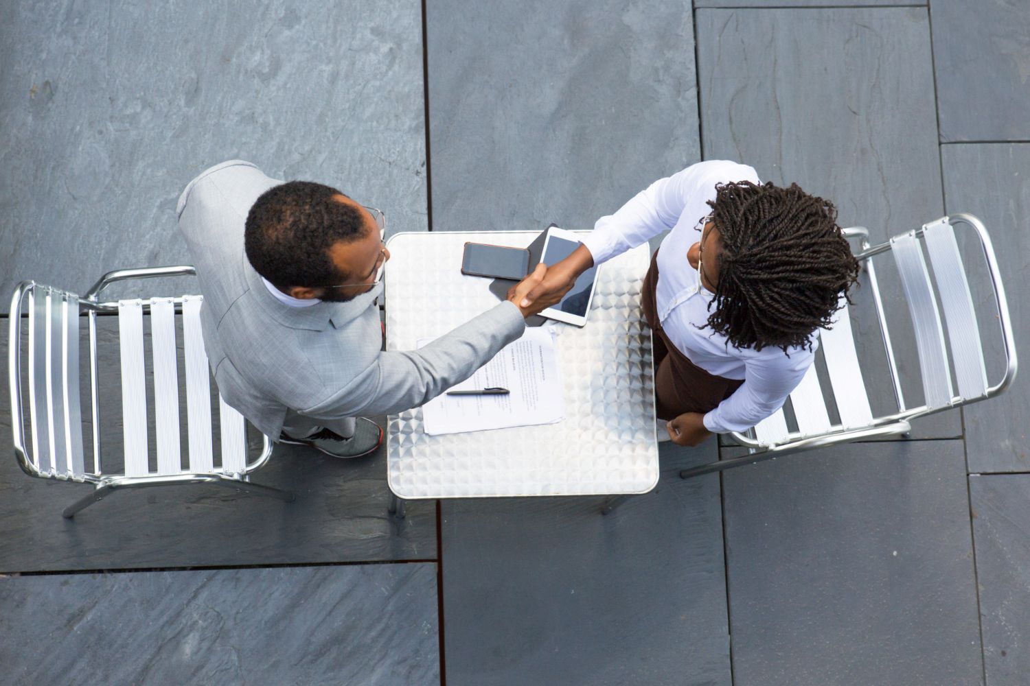 Business partners shaking hands at the end of a meeting