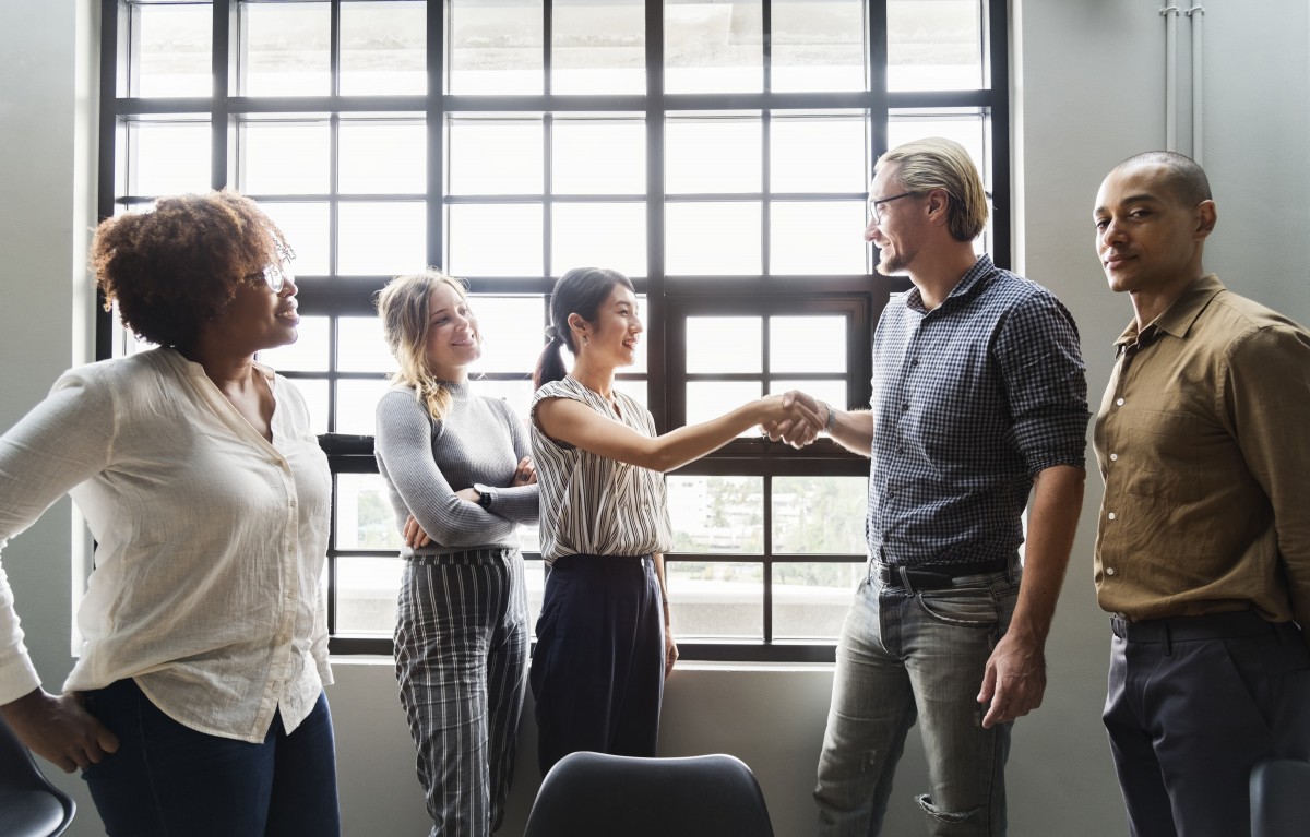 Boss shaking hands with a new team member