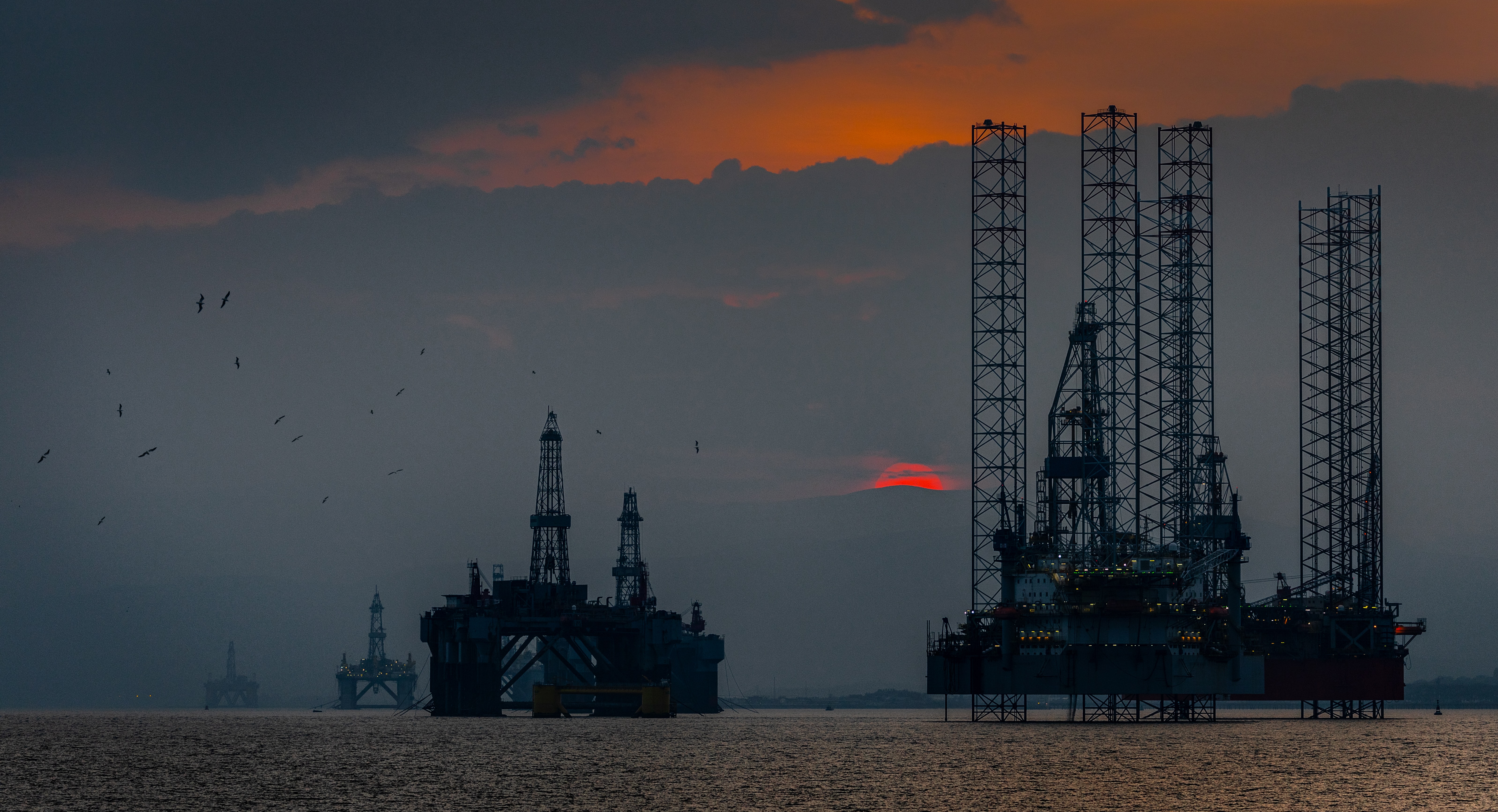 A group of oil rigs in the ocean