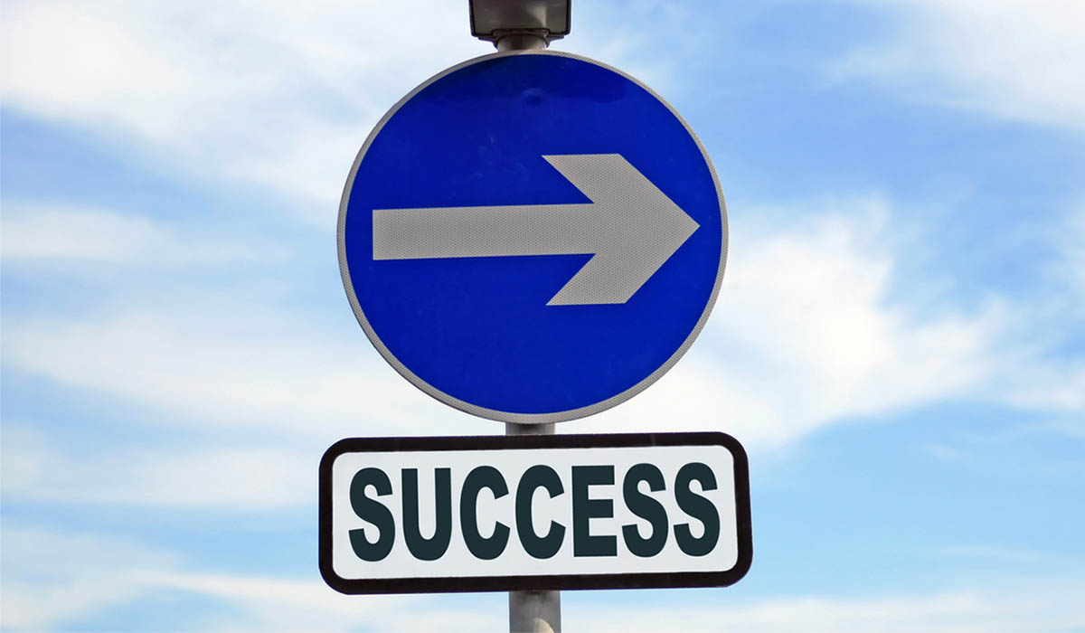 Sign with arrow pointing right and the word "success" beneath it