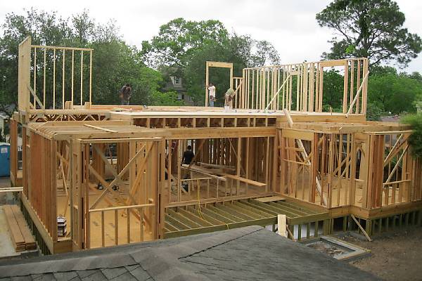 Construction workers on top of a house frame