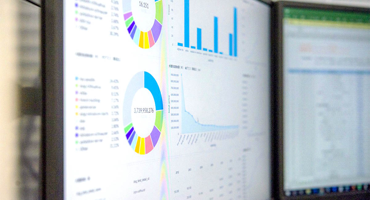 computer monitors with charts and graphs