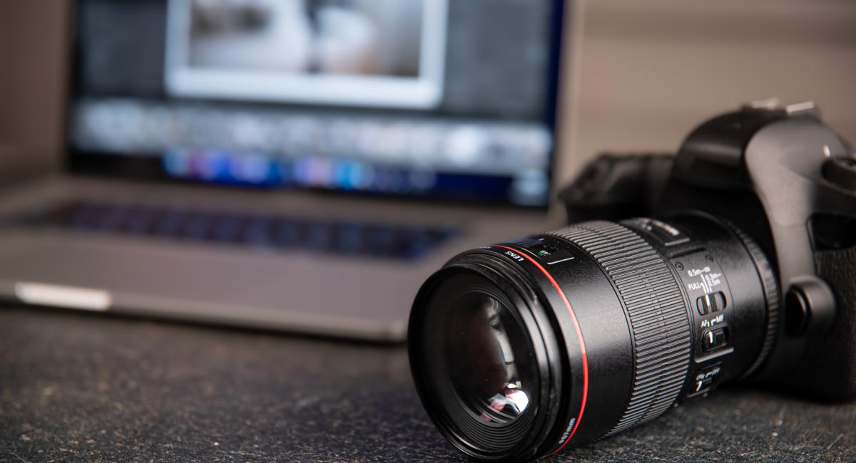 A camera and laptop on a table