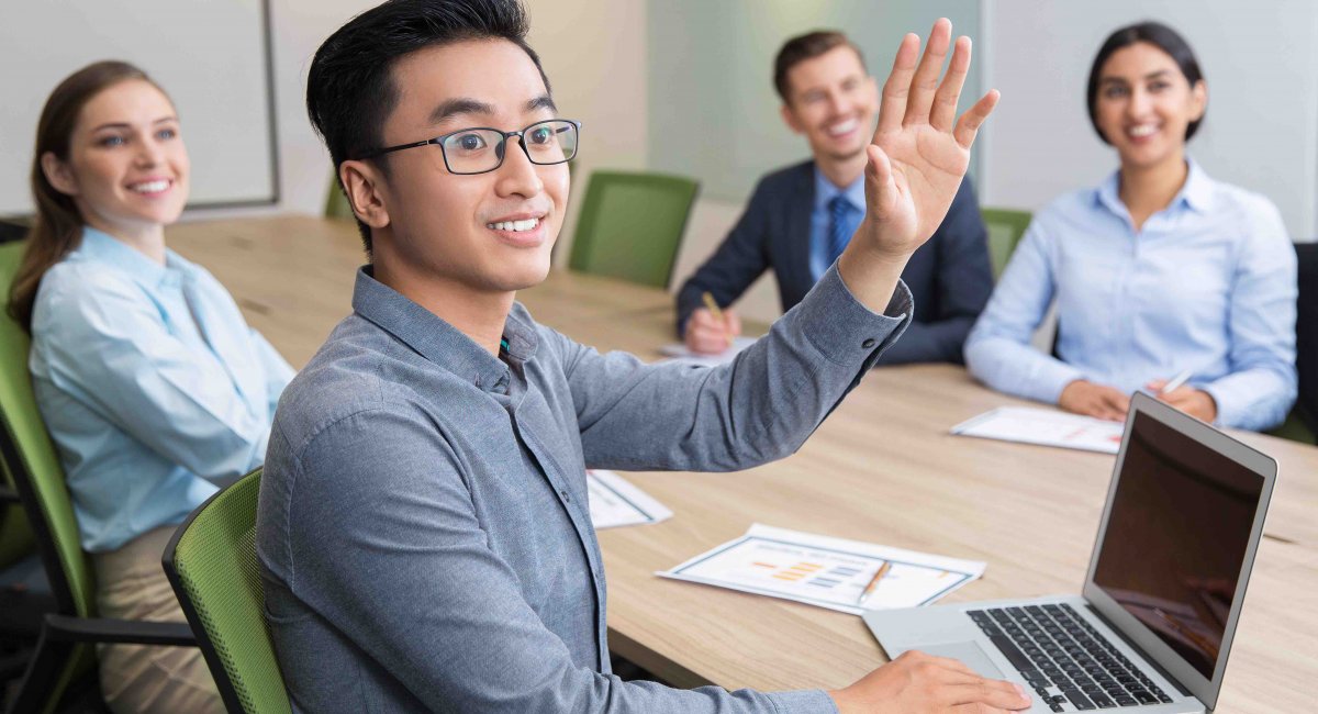 young man Asian raising hand group table class