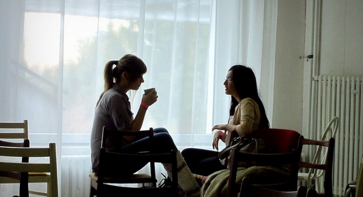 two women sitting in an office