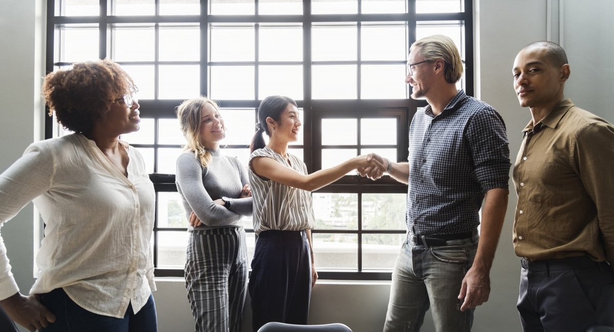 Boss shaking hands with a new team member