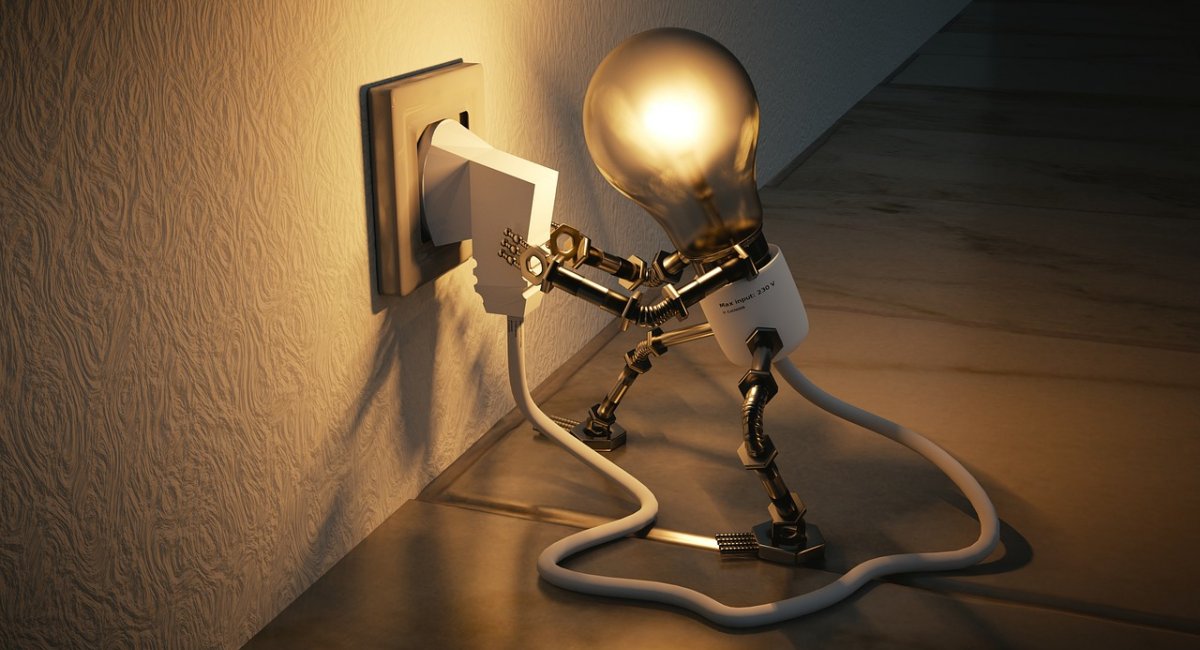 Plugging a light bulb into a socket